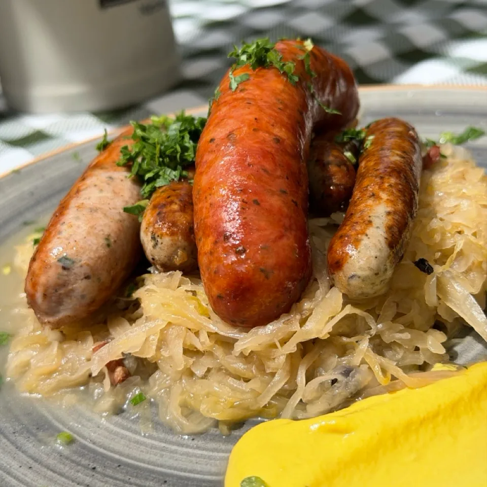 Different bratwurst on sauerkraut